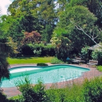 Country garden pool with summer house